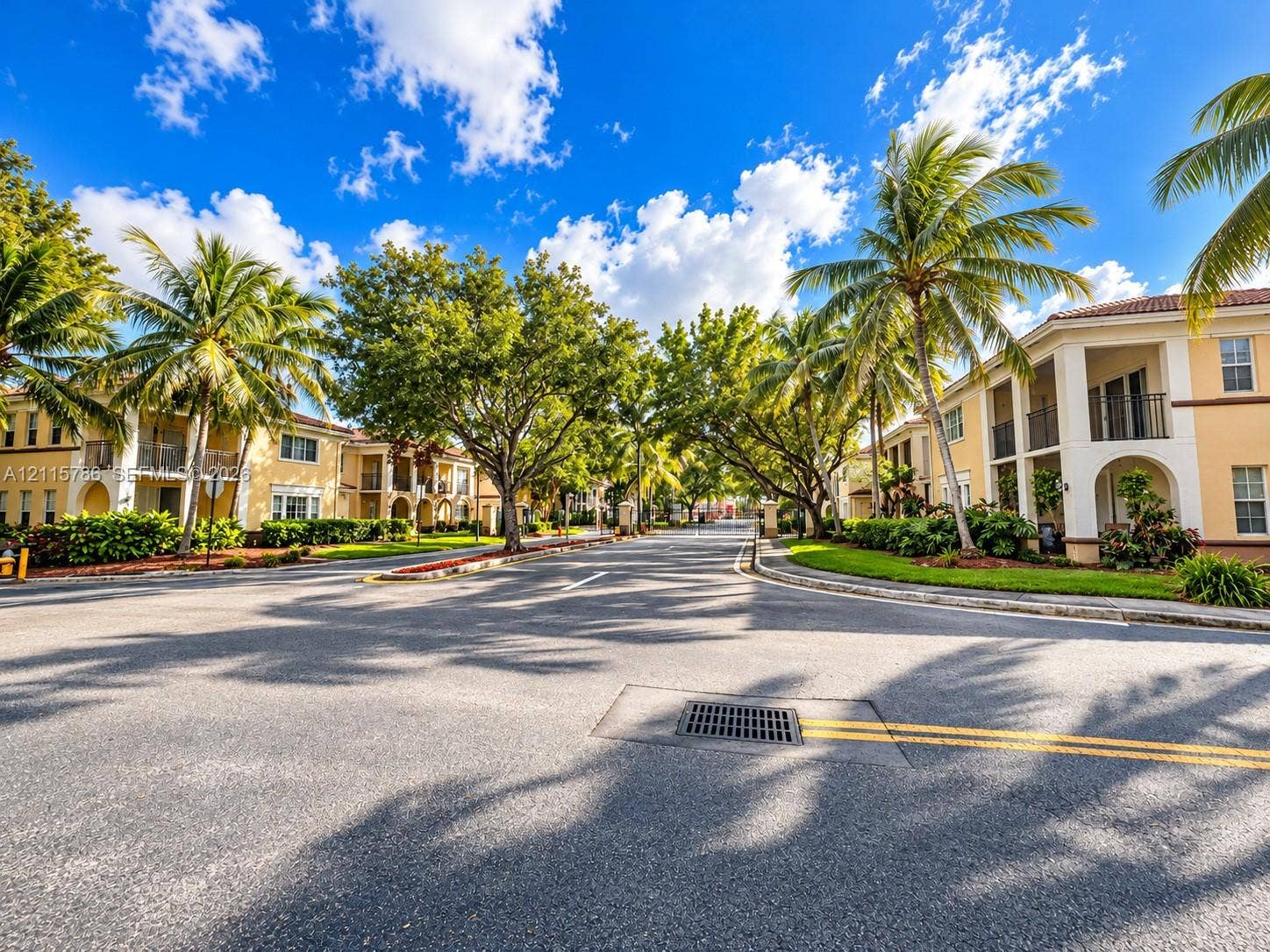 2494 Centergate Drive, #202, Miramar, Miramar, FL 33025 Multi-story residential buildings featuring stucco facades, arched entryways, private balconies, and extensive mature landscaping