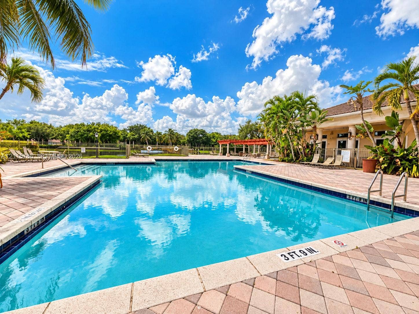 2494 Centergate Drive, #202, Miramar, Miramar, FL 33025 Swimming pool with paver decking, pergola, and mature palm landscaping