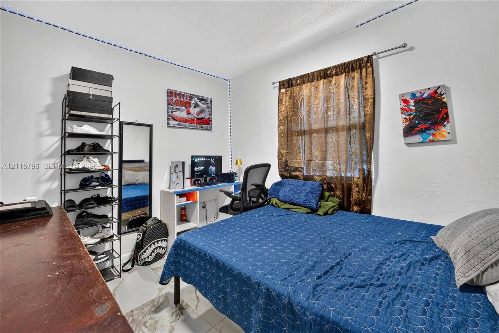 Room featuring white walls and large-format tile flooring
