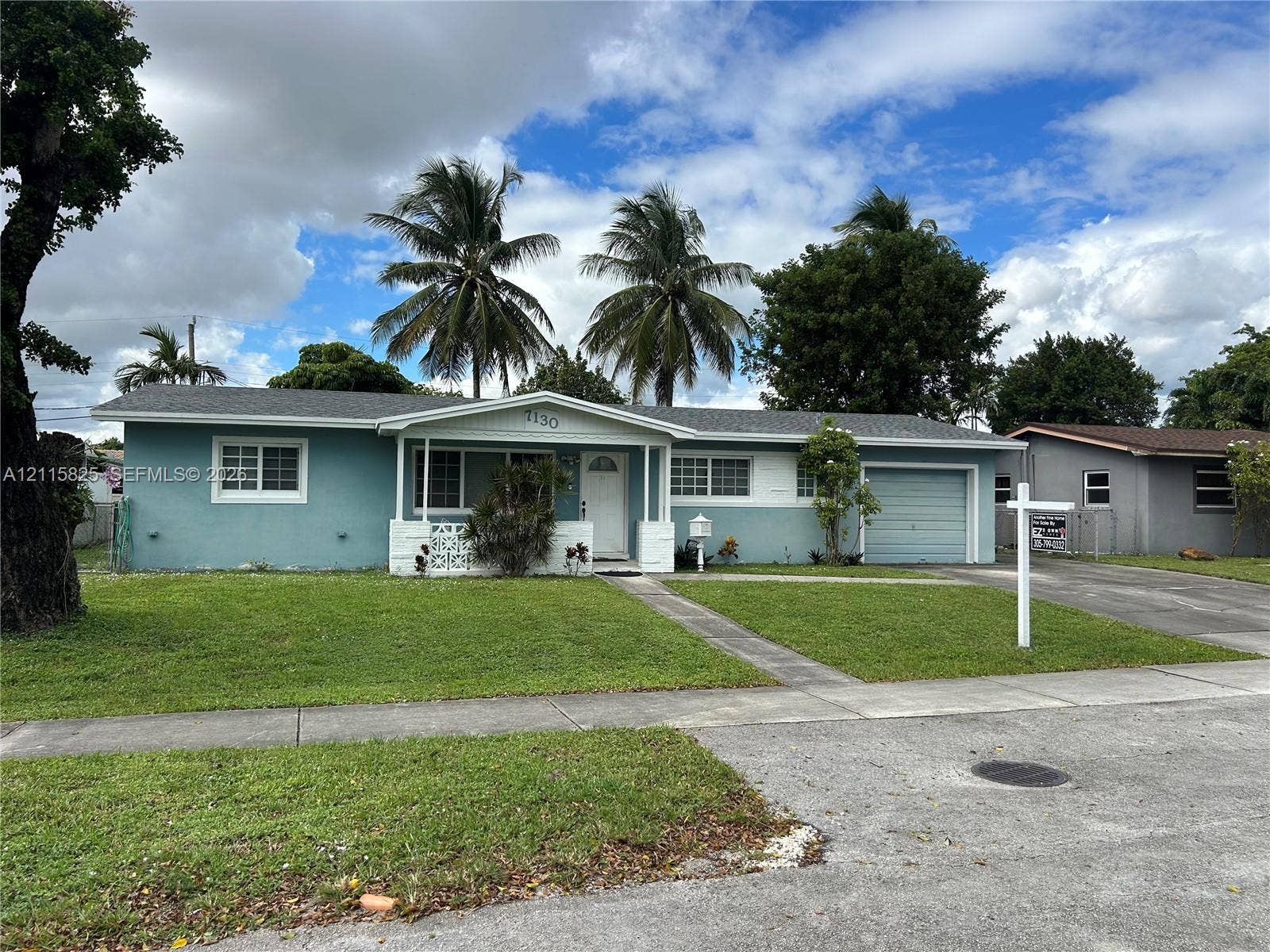 7130 W 12th Court, Hialeah, FL 33014 Single-story residence featuring a covered front porch, attached garage, shingled roof, and exterior masonry construction