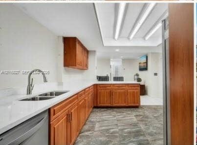 411 Wilma Circle, #0, Riviera Beach, Riviera Beach, FL 33404 Kitchen featuring wood cabinetry, white countertops, double-basin stainless steel sink with arched faucet, recessed tray ceiling lighting, and stone-finish tile flooring