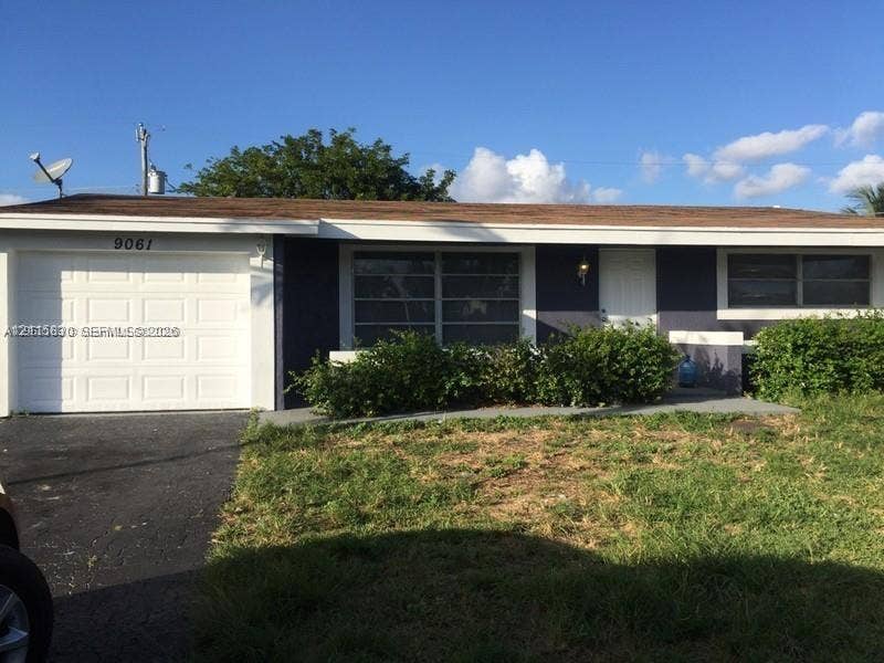 9061 NW 25th Court, #0, Sunrise, Sunrise, FL 33322 Single-story residence featuring an attached garage, horizontal sliding windows, and a paved driveway