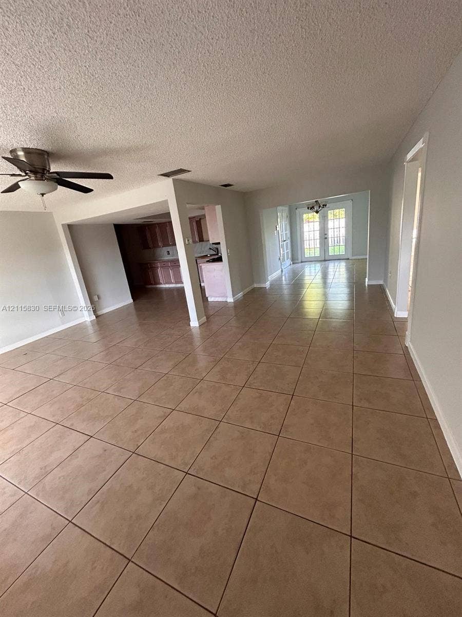 9061 NW 25th Court, #0, Sunrise, Sunrise, FL 33322 Open-concept floor plan featuring ceramic tile flooring, a multi-blade ceiling fan, recessed lighting, and double glass-paned doors