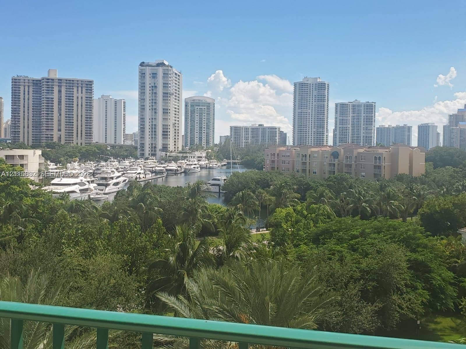 19900 E Country Club Drive, #607, Aventura, Aventura, FL 33180 Expansive urban skyline backdrop with waterway access, marina with boat slips, and dense canopy of mature trees