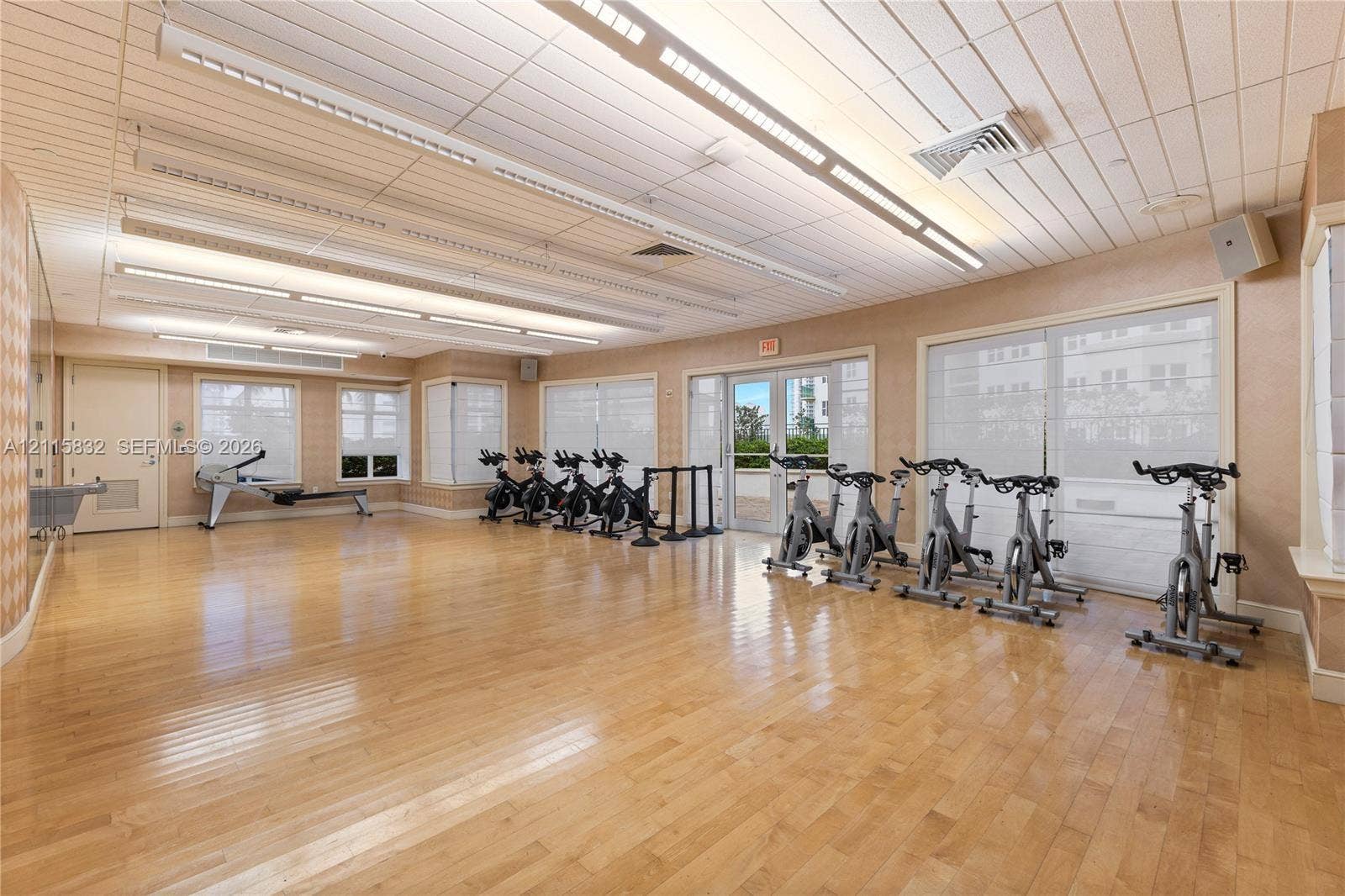 19900 E Country Club Drive, #607, Aventura, Aventura, FL 33180 Fitness room featuring wood-finish flooring, linear recessed lighting, plank-style ceiling, and glass-paneled exterior doors