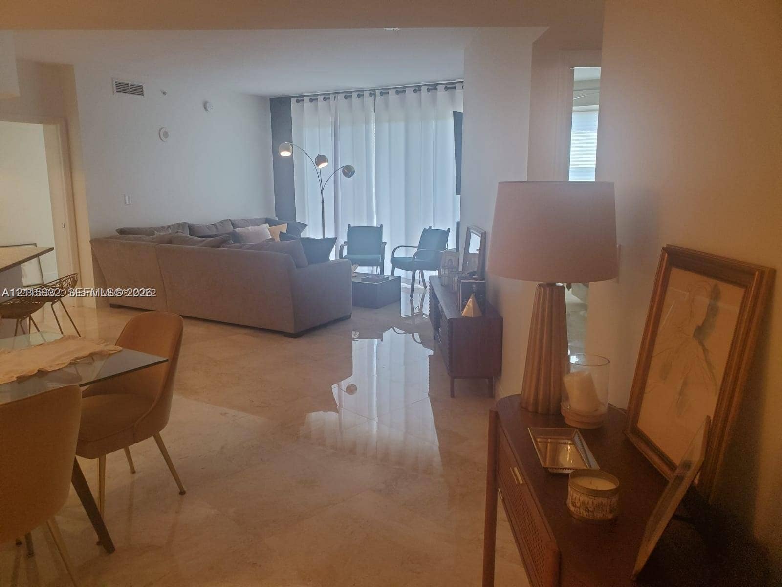 19900 E Country Club Drive, #607, Aventura, Aventura, FL 33180 Polished stone flooring, floor-to-ceiling glass wall, and neutral wall tones
