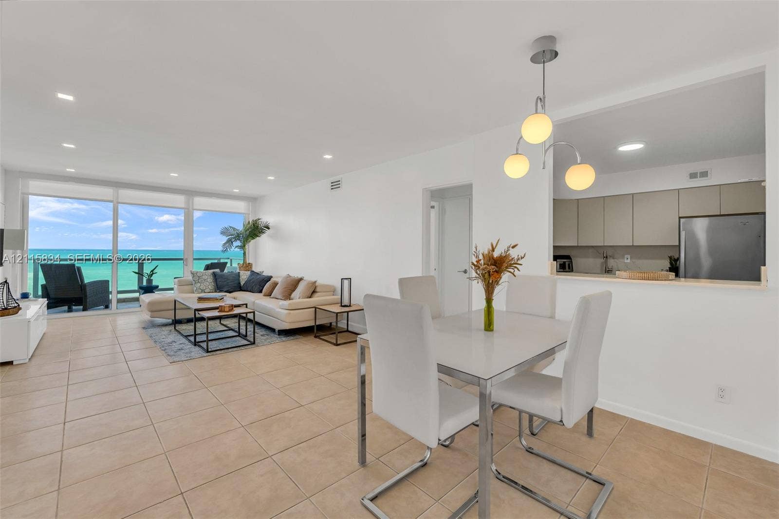 5161 Collins Avenue, #1717, Miami Beach, Miami Beach, FL 33140 Open-concept interior featuring large-format tile flooring, floor-to-ceiling glass doors, and recessed lighting