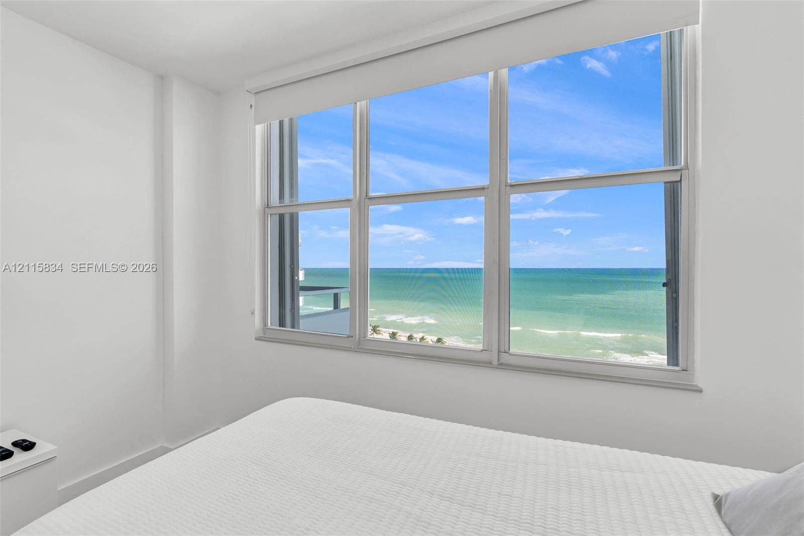 5161 Collins Avenue, #1717, Miami Beach, Miami Beach, FL 33140 Large multi-pane window with a retractable shade, providing expansive ocean and coastline scenery