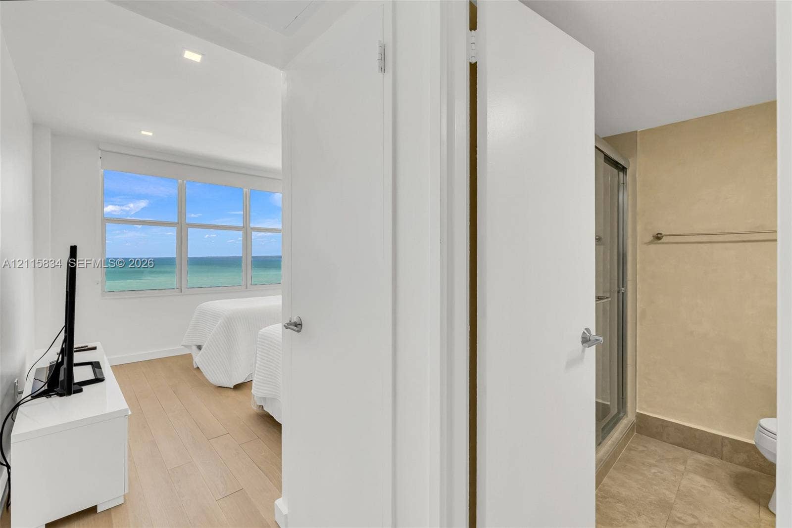 5161 Collins Avenue, #1717, Miami Beach, Miami Beach, FL 33140 Expansive window with ocean scenery, wood-finish flooring, recessed lighting, and a walk-in shower with tile surround