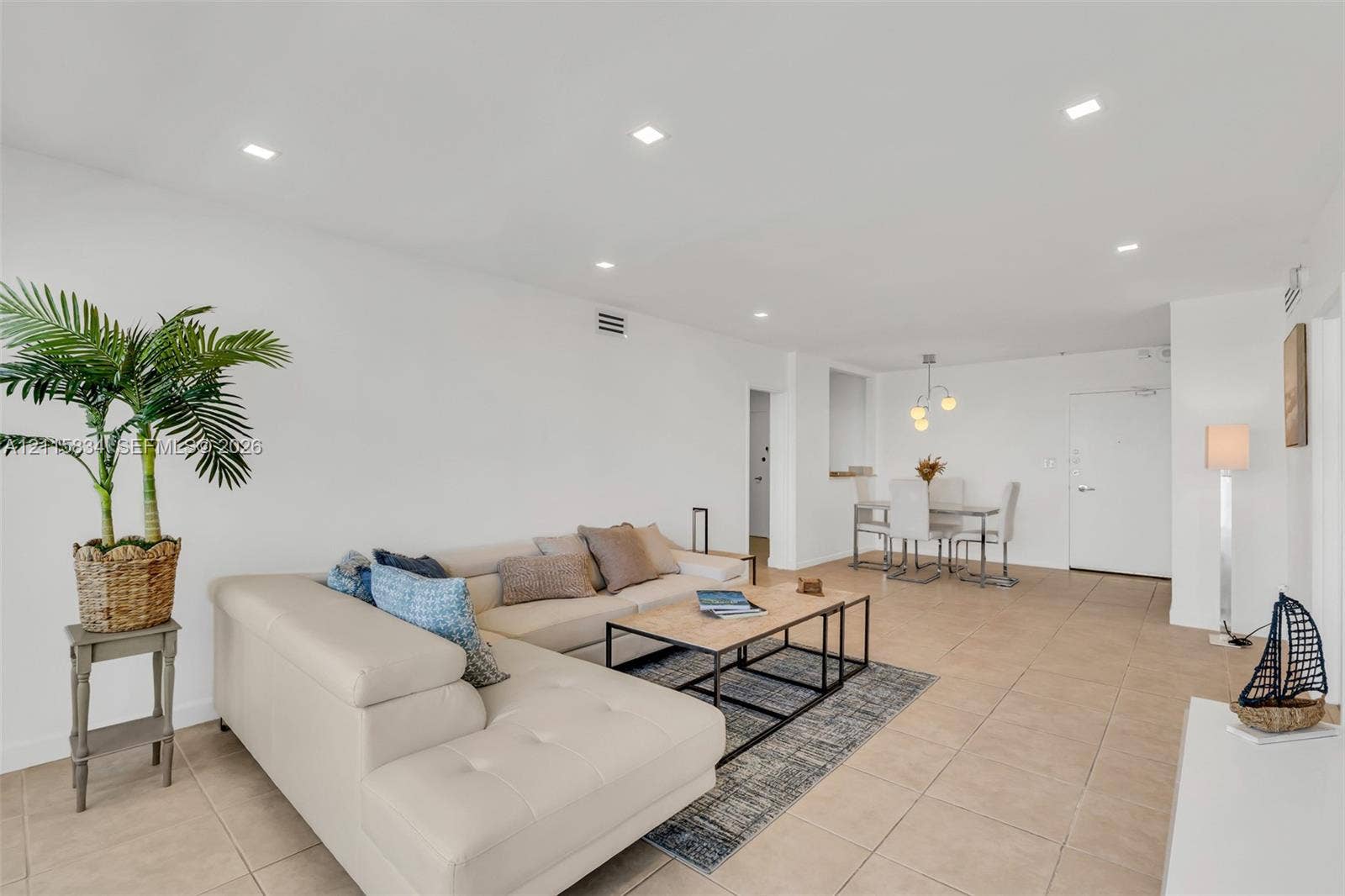 5161 Collins Avenue, #1717, Miami Beach, Miami Beach, FL 33140 Open-concept interior featuring neutral tile flooring, recessed ceiling lighting, and a modern multi-globe chandelier