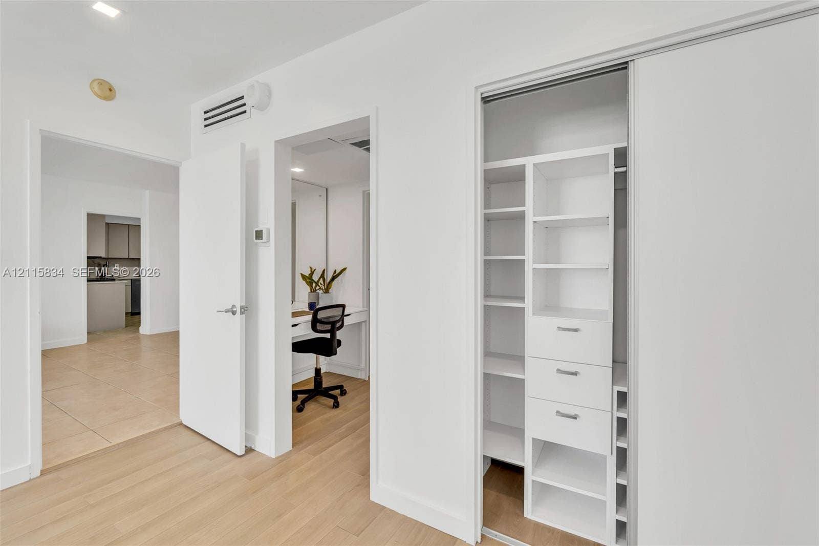 5161 Collins Avenue, #1717, Miami Beach, Miami Beach, FL 33140 Custom-built walk-in closet featuring integrated shelving and drawer organizers, light-toned wood-finish flooring, and recessed ceiling lighting
