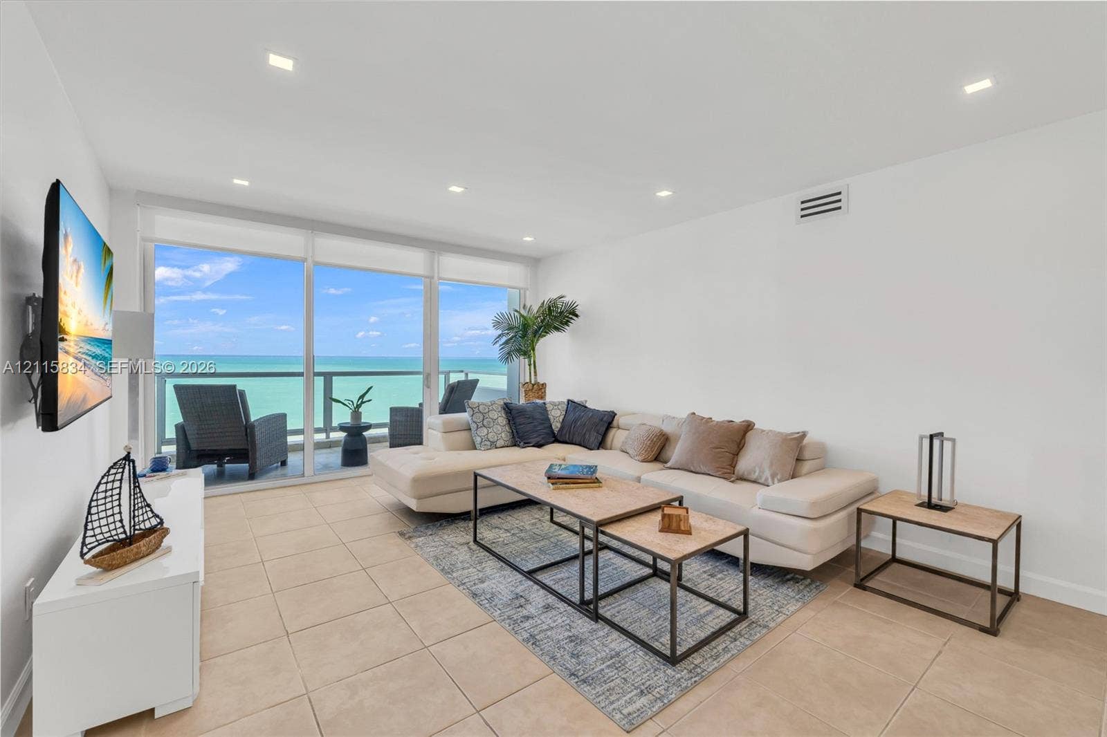 5161 Collins Avenue, #1717, Miami Beach, Miami Beach, FL 33140 Living area featuring ceramic tile flooring, recessed lighting, and floor-to-ceiling glass sliding doors opening to a private balcony with ocean frontage