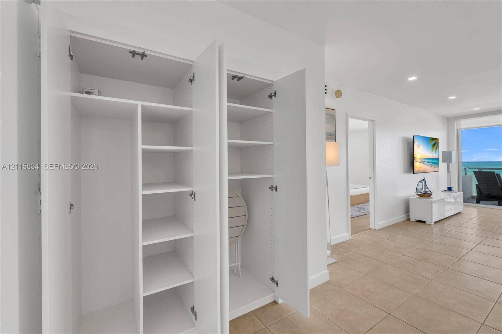 5161 Collins Avenue, #1717, Miami Beach, Miami Beach, FL 33140 Built-in cabinetry featuring white laminate doors and adjustable shelving, complemented by tile flooring and recessed lighting