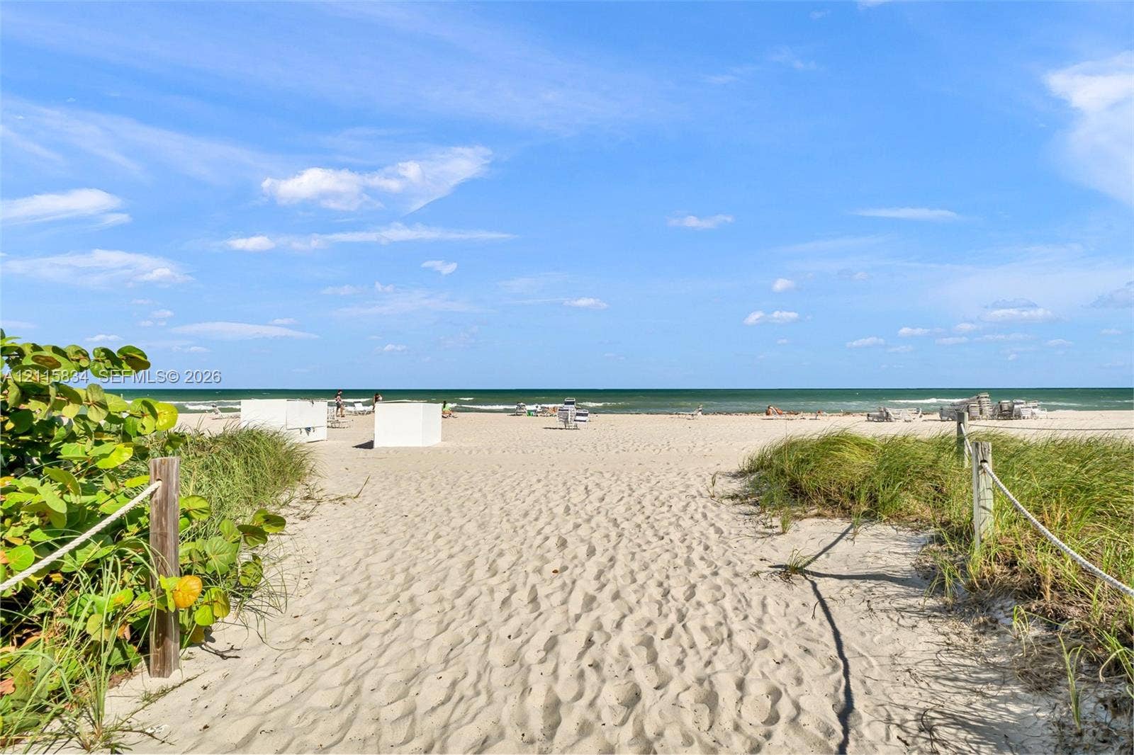 5161 Collins Avenue, #1717, Miami Beach, Miami Beach, FL 33140 Sandy beach access featuring a sand-covered path, native coastal vegetation, and rope-style perimeter fencing