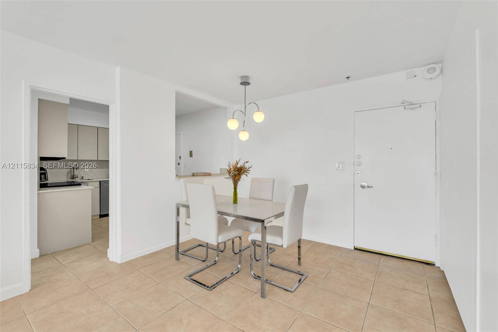 5161 Collins Avenue, #1717, Miami Beach, Miami Beach, FL 33140 Neutral-toned tile flooring, three-globe pendant lighting fixture, and solid-panel door with integrated security hardware