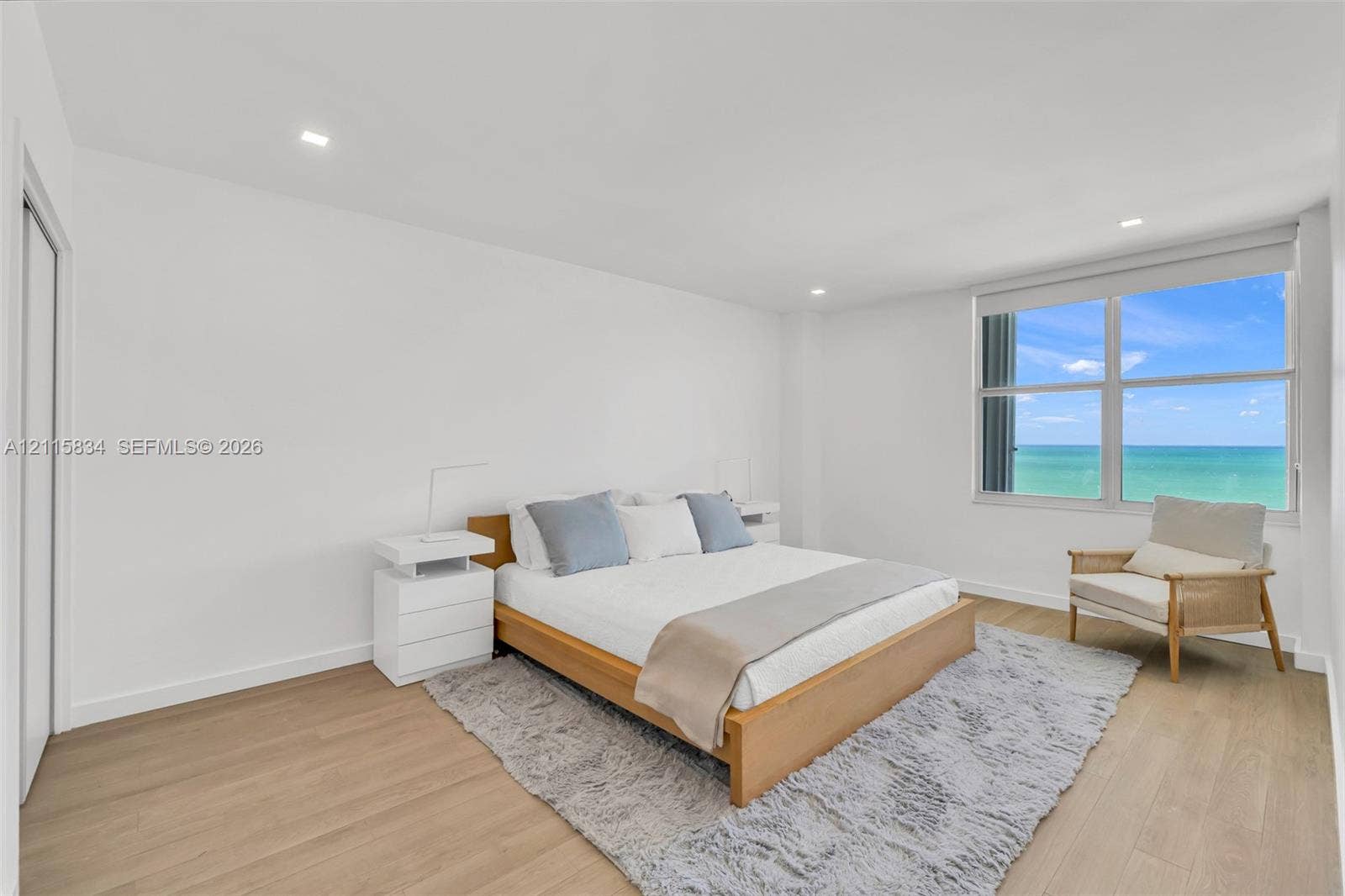 5161 Collins Avenue, #1717, Miami Beach, Miami Beach, FL 33140 Neutral-toned interior featuring wood-finish flooring, recessed lighting, and expansive windows with ocean scenery
