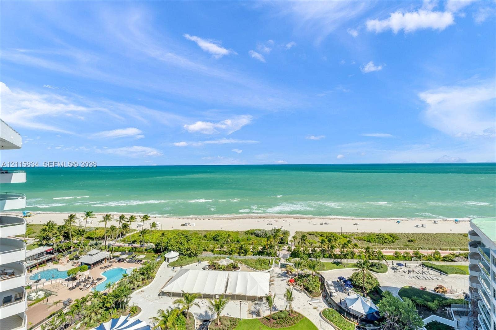 5161 Collins Avenue, #1717, Miami Beach, Miami Beach, FL 33140 Elevated coastal scenery featuring direct ocean frontage, a sandy beach, and palm-lined grounds with multiple pools