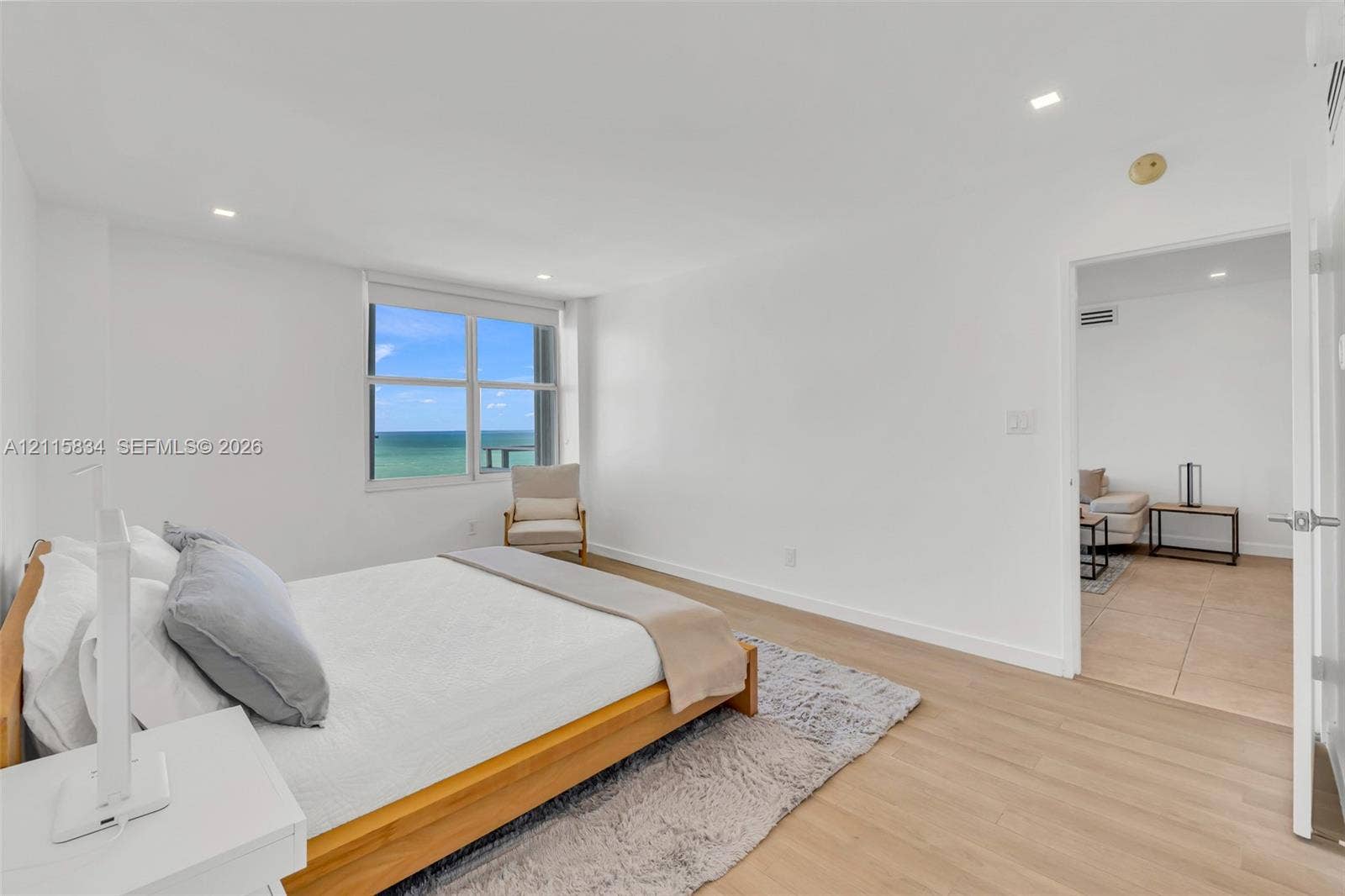 5161 Collins Avenue, #1717, Miami Beach, Miami Beach, FL 33140 Spacious room featuring wood-finish flooring, recessed lighting, and a large window showcasing a prominent ocean backdrop