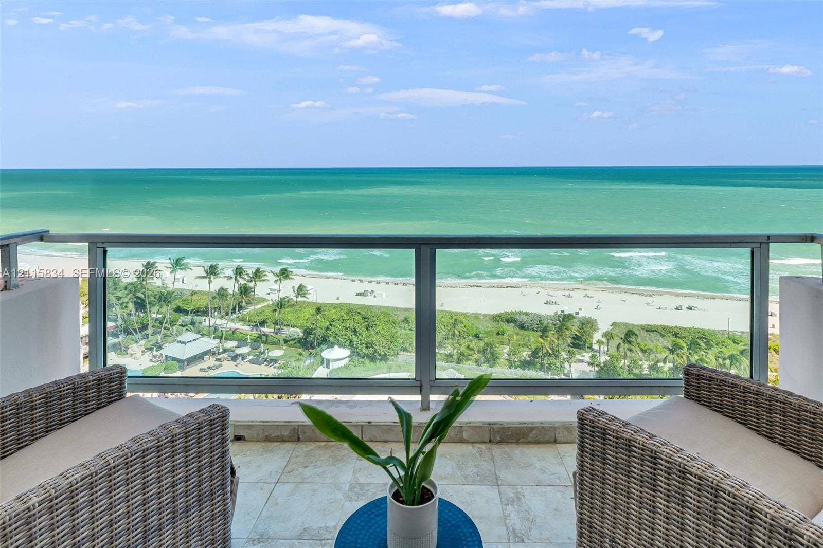 5161 Collins Avenue, #1717, Miami Beach, Miami Beach, FL 33140 Private balcony with a metal and glass railing, stone flooring, and expansive coastal water backdrop