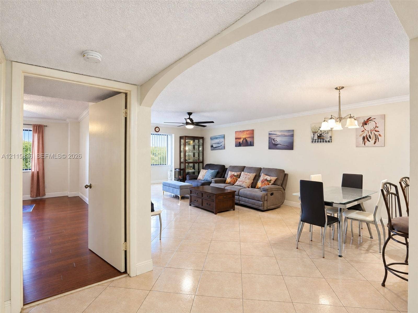 8000 Hampton Boulevard, #311, North Lauderdale, North Lauderdale, FL 33068 Open-concept interior featuring arched architectural detailing, polished ceramic tile flooring, wood-finish flooring, and a multi-arm chandelier
