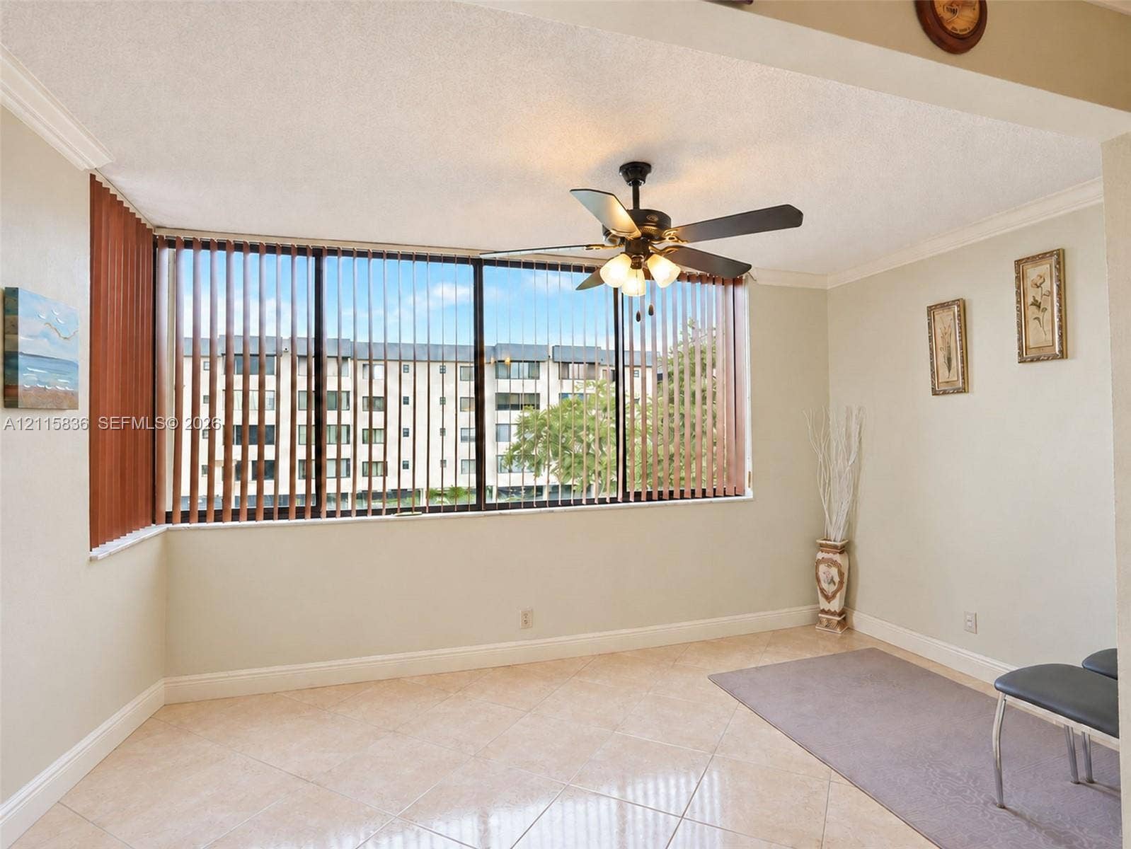 8000 Hampton Boulevard, #311, North Lauderdale, North Lauderdale, FL 33068 Floor-to-ceiling windows with vertical blinds, tile flooring, and a ceiling fan with integrated lighting