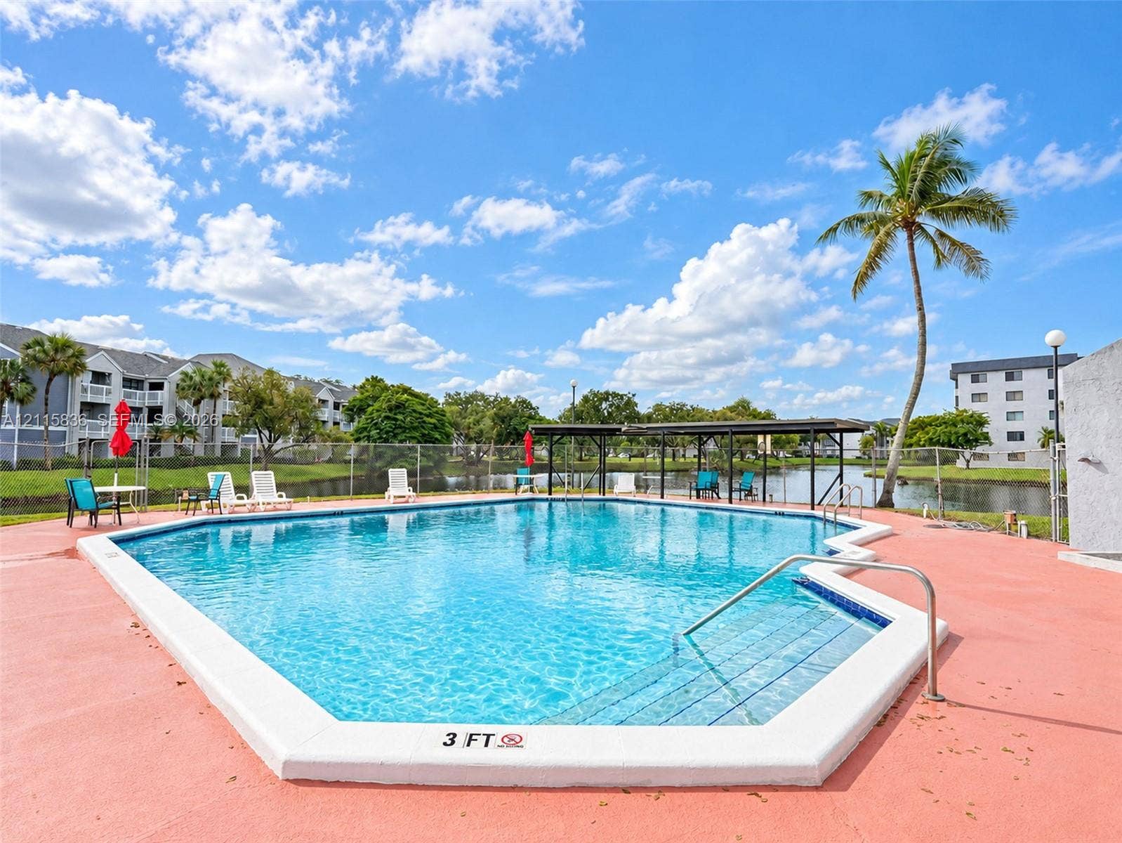 8000 Hampton Boulevard, #311, North Lauderdale, North Lauderdale, FL 33068 In-ground swimming pool featuring a concrete deck, tiled entry steps, and metal handrails