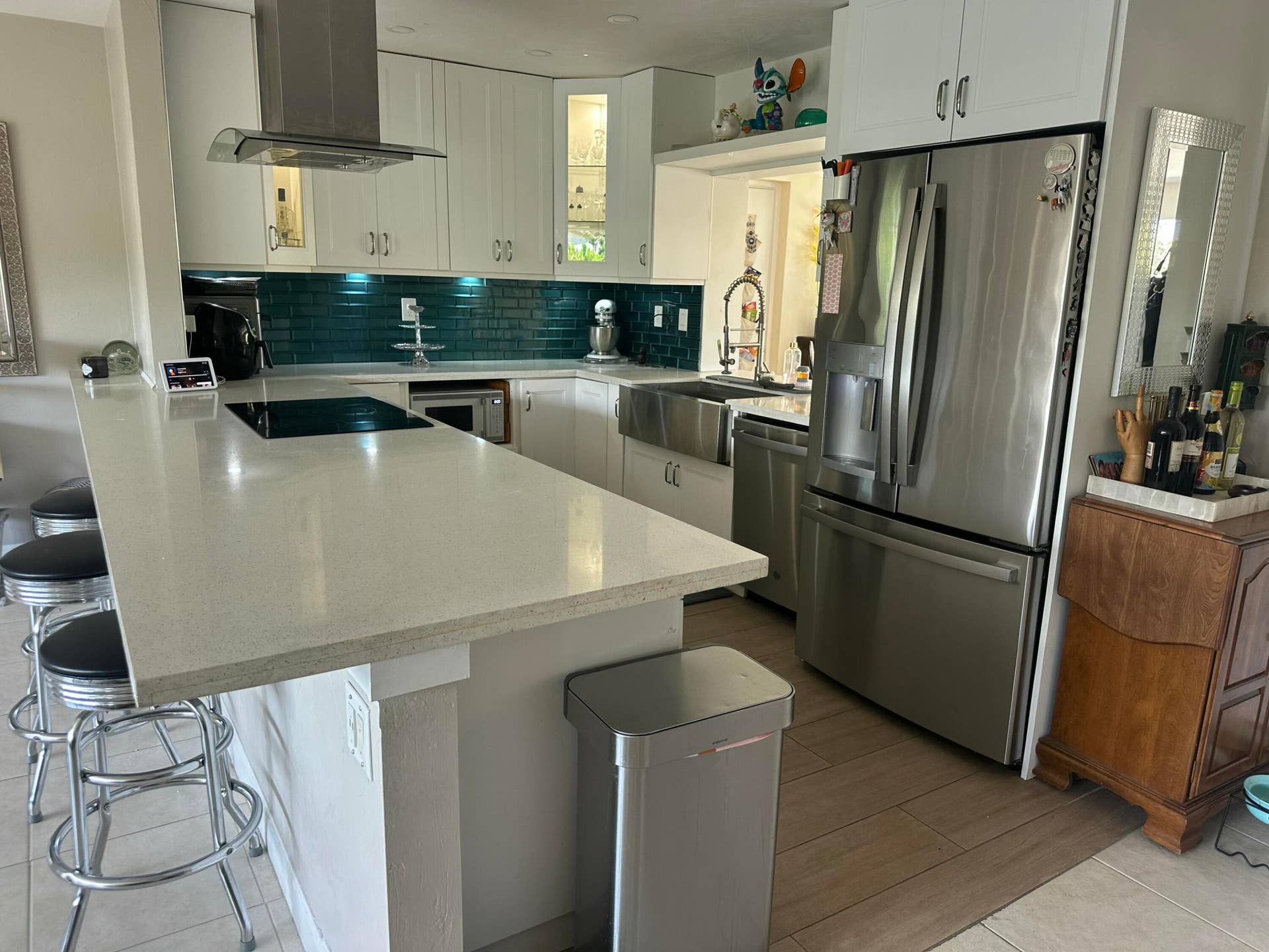 Ample counter space, beautiful tile backsplash and white custom wood cabinetry