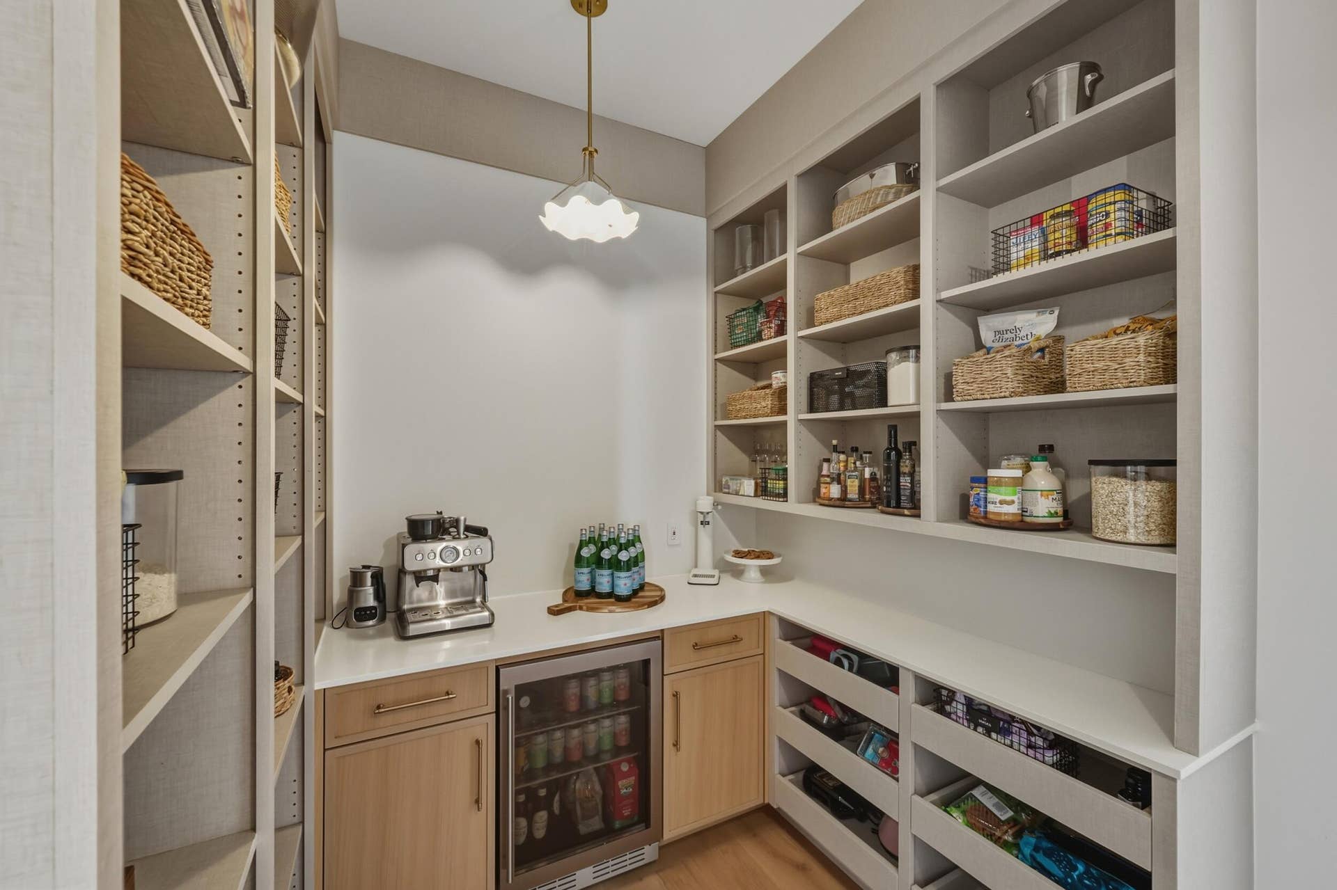 Walk-in pantry with quartz counters, beverage fridge & plenty of storage.