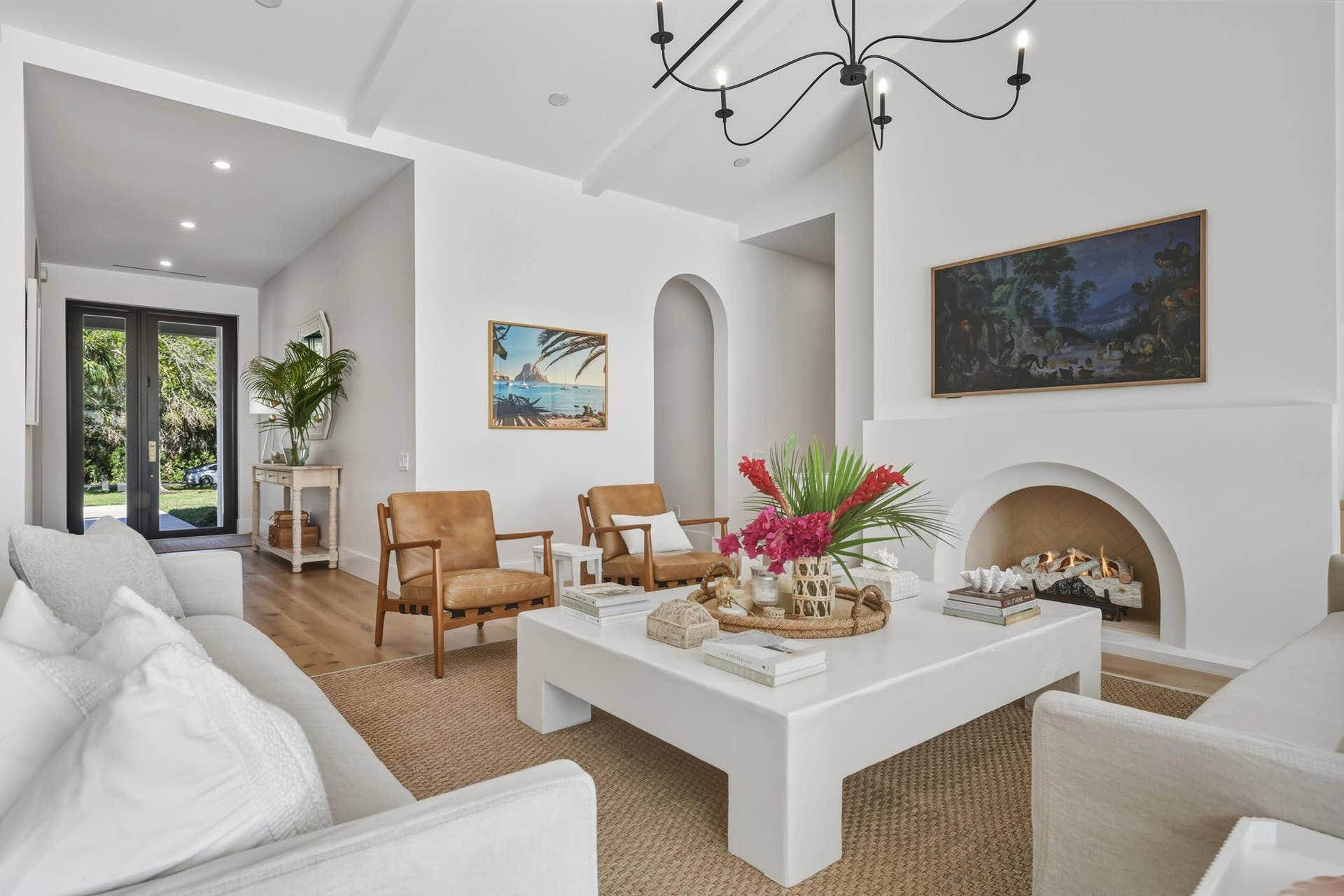 Formal living room is oversized with custom coffee table to fit the space & arched isokern fireplace with herringbone detail