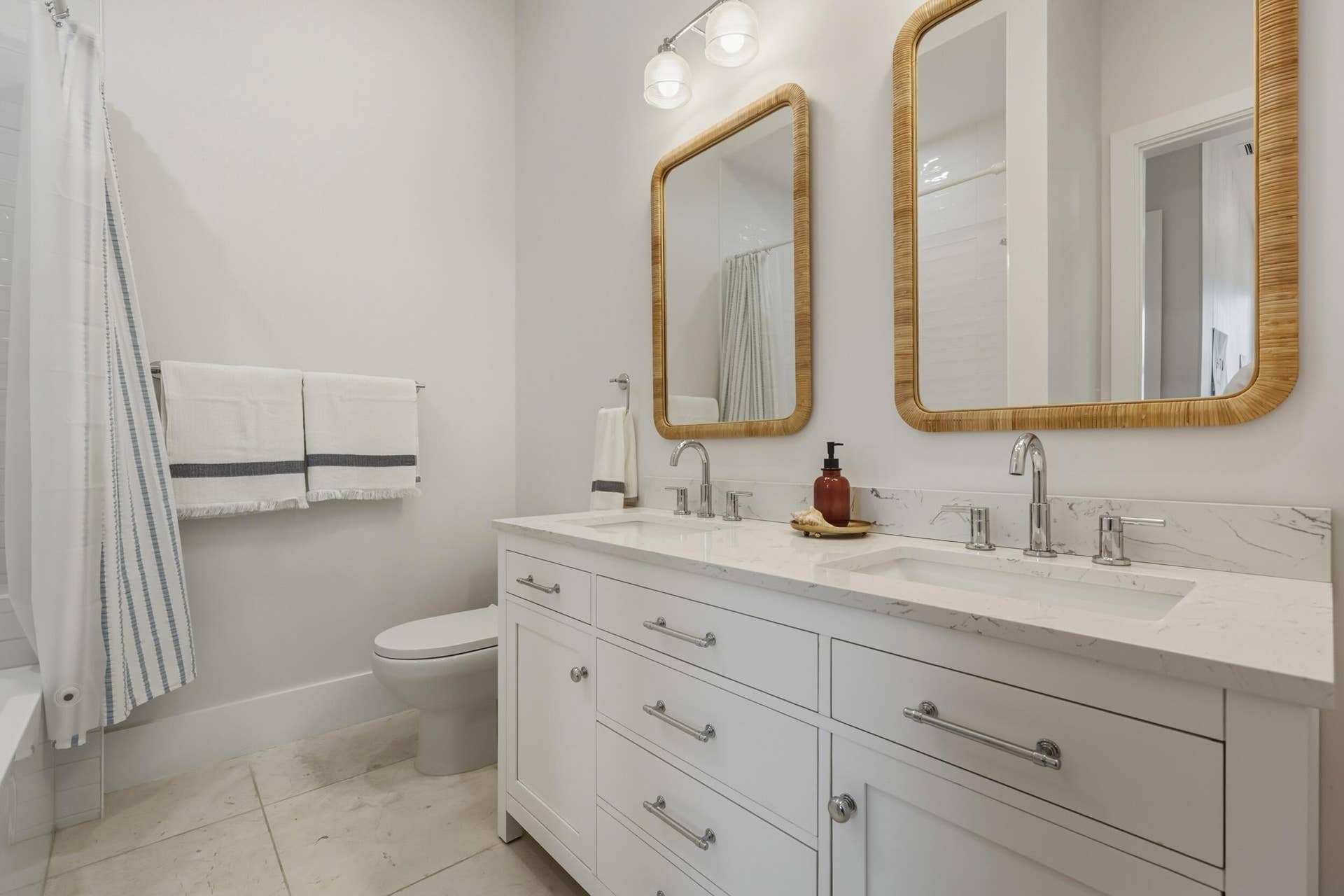 Double sink ensuite with honed marble flooring
