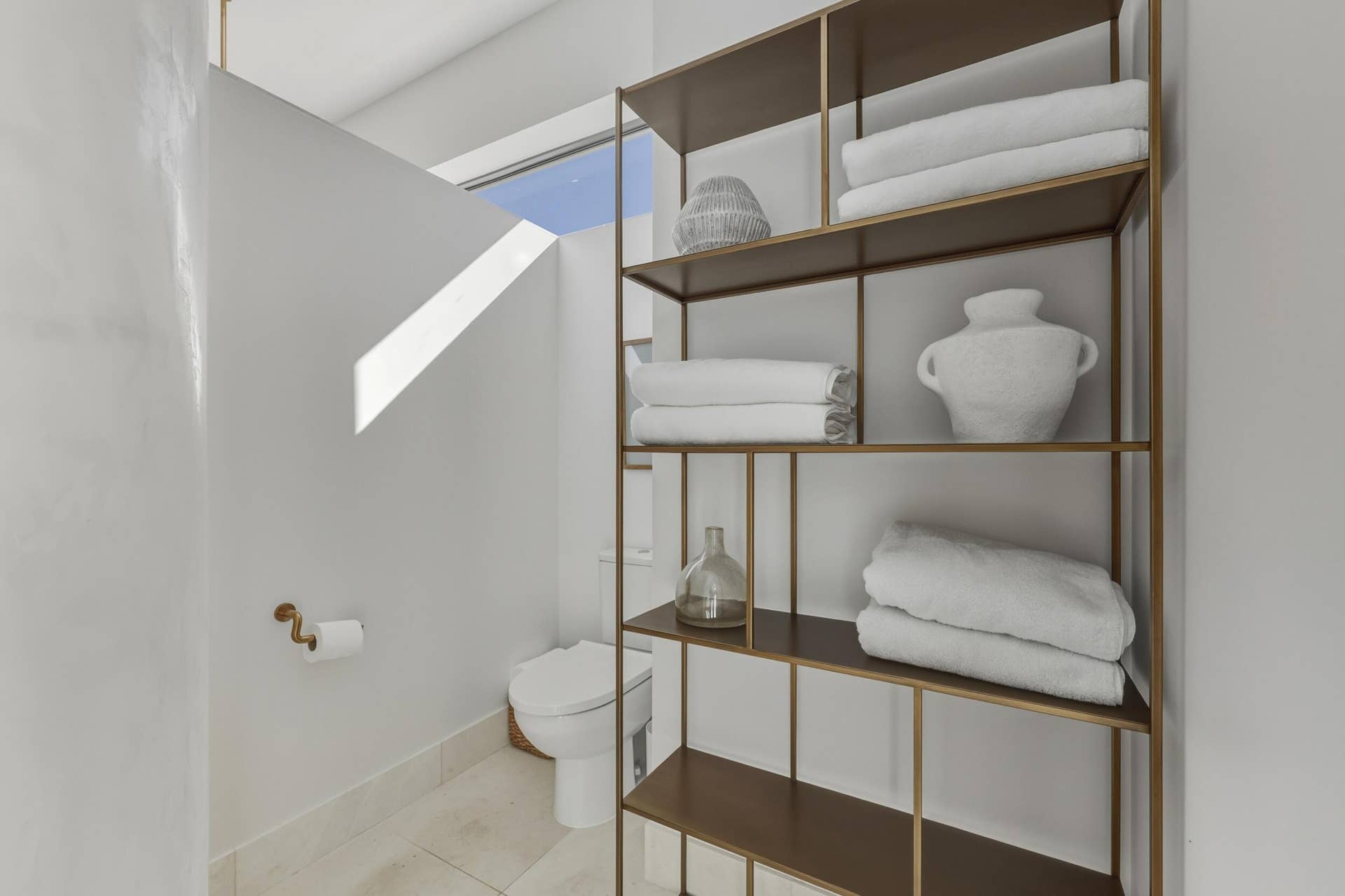 Toilet area with towel storage