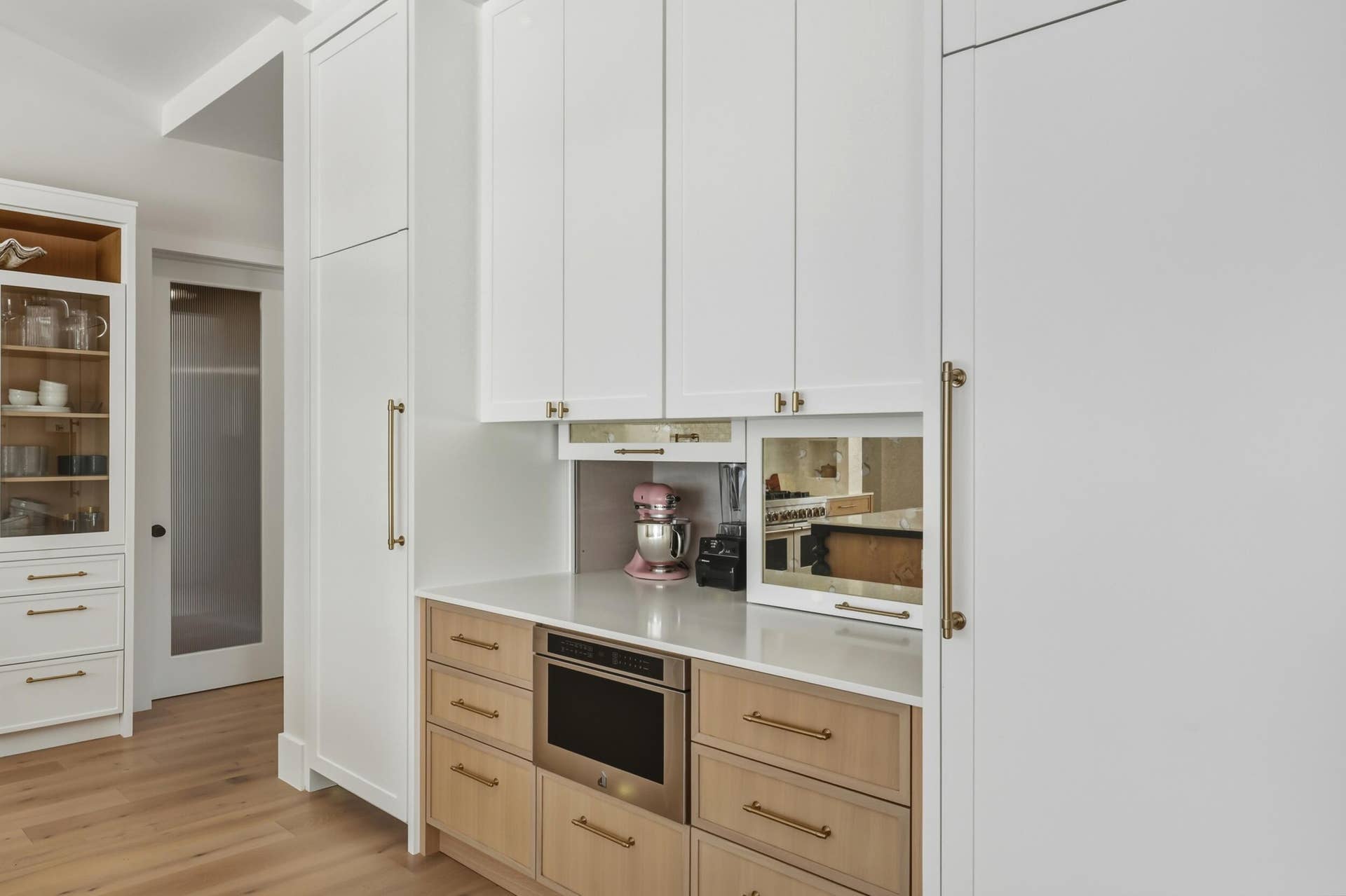 Separate full size paneled fridge & freezer tower with cabinetry going to ceiling for extra strorage