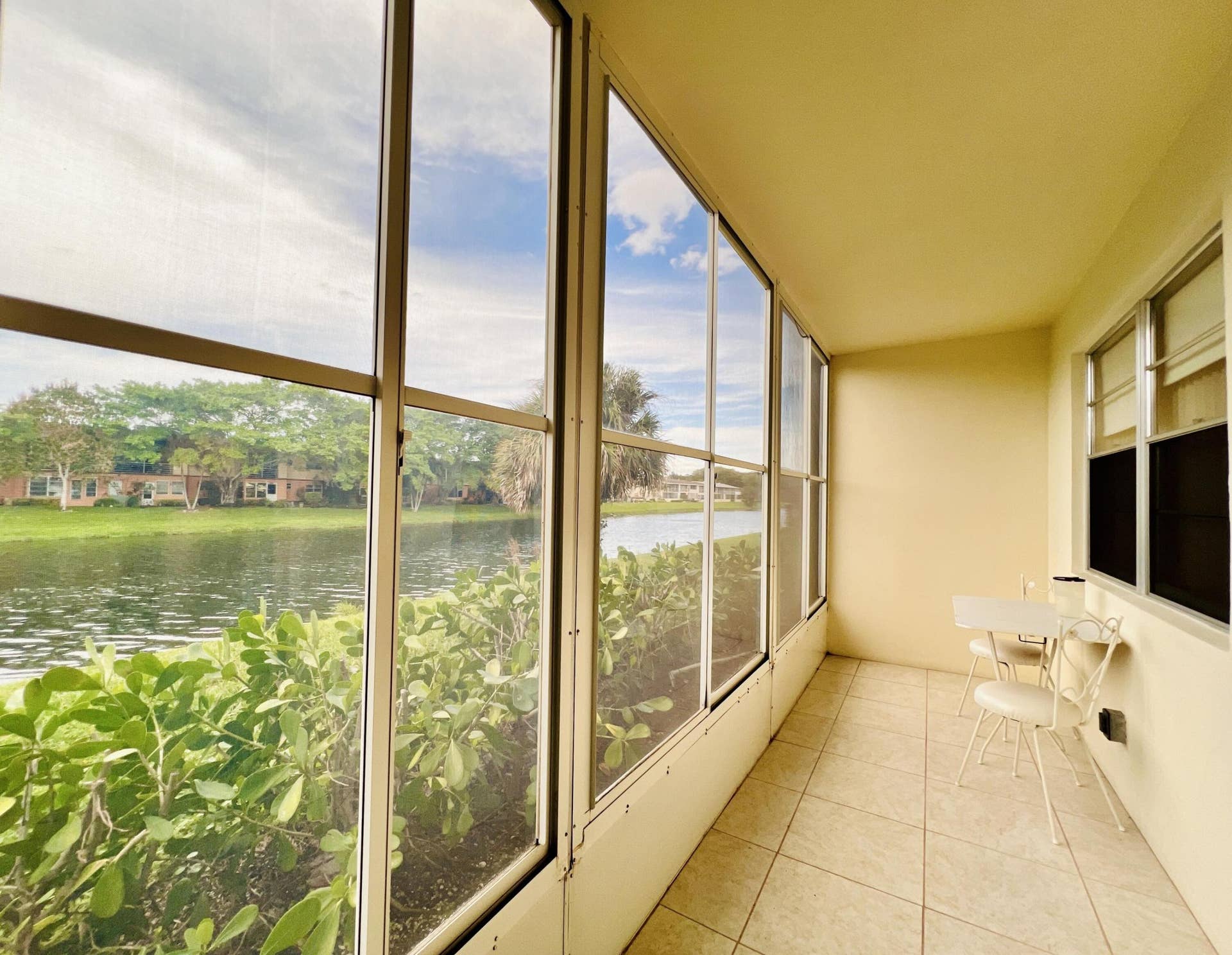 27 Sheffield B, West Palm Beach, FL 33417 Enjoy the Pretty & Peaceful Water Views from the Long Lanai