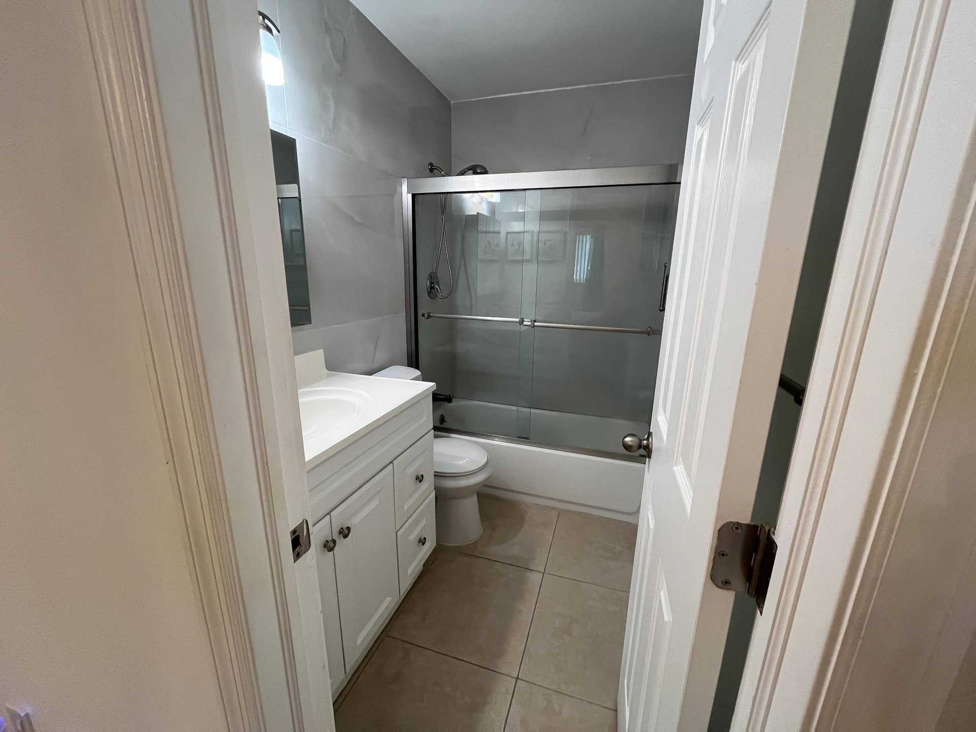 Updated primary en-suite bathroom with frameless shower doors