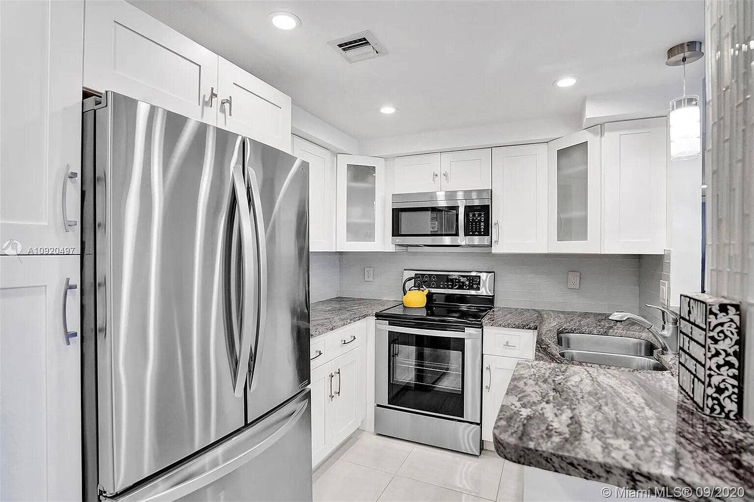 Open kitchen with stainless appliances and creative cabinets