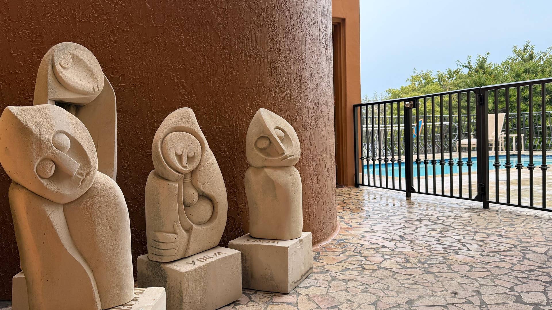 a scultpure garden leads to the pool