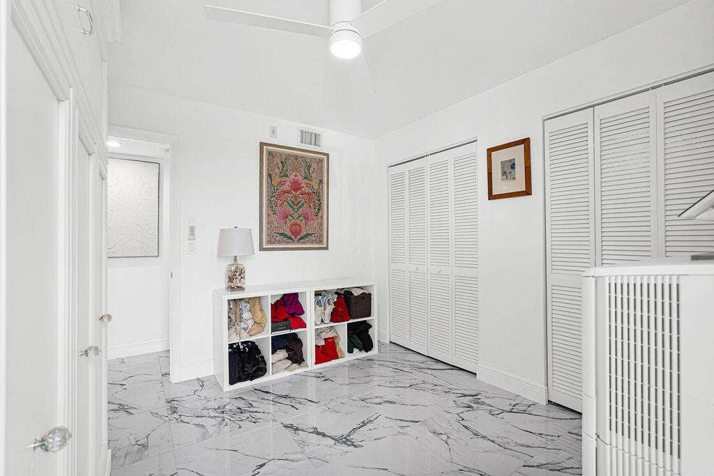 2nd bedroom with sliding glass door to balcony. Beautiful 24" Calcutta Spanish porcelain tile throughout