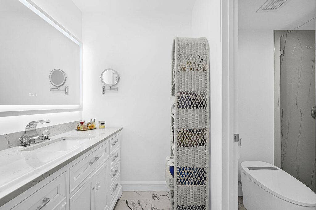 Beautiful completely remodeled primary bath with quartz countertops and lighted/heated mirror