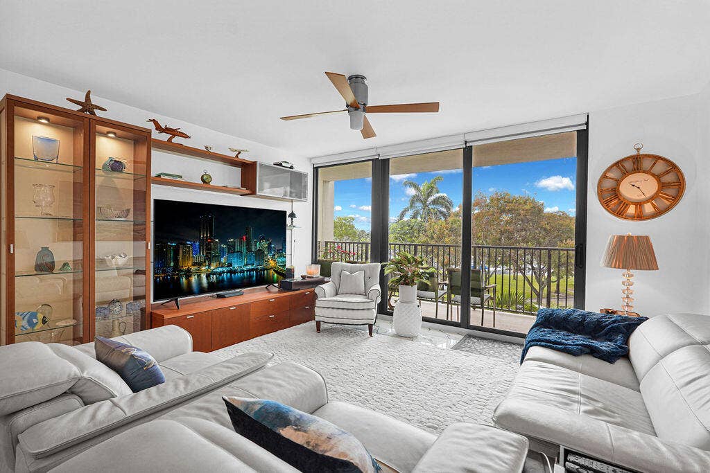 Large living room with new impact sliding glass doors to balcony