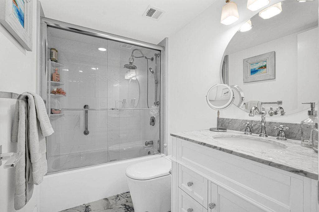 Remodeled 2nd bath with glass shower doors and quartz countertops