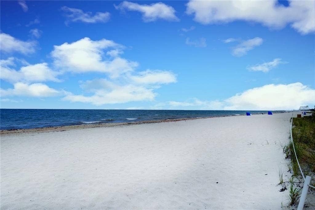 BEACH AND BOAT LOVERS DREAM LOCATION!.., FEATURING PRIVATE DEEDED BEACH ACCESS, COMMUNITY BOAT DOCK, NO FIXED BRIDGES, 1 CANAL FROM THE INTRACOASTAL WITH 6 BOAT SLIPS! Located in desirable North Leisure Gardens COMPLETELY REMODELED 2-bed, 2-bath, 1st floor, corner unit features EVERYTHING BRAND NEW!, a custom kitchen with quartz countertops, soft-close cabinets, stainless-steel appliances and ALL NEW, ELECTRIC, PLUMBING, HWH AND AC UNIT.