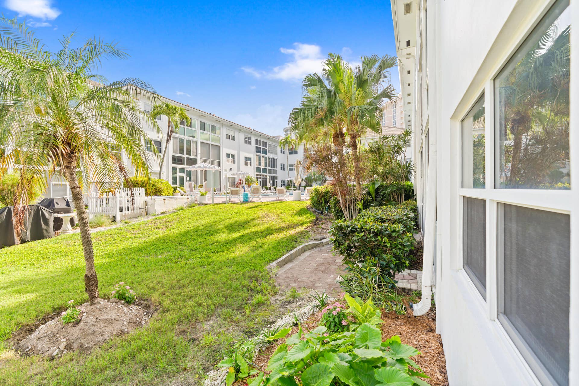 IMPACT GLASS ENCLOSED PATIO WITH DIRECT ACCESS TO COURTYARD POOL, BBQ AREA, SHUFFLEBOARD, AND CANAL BREEZEWAY.