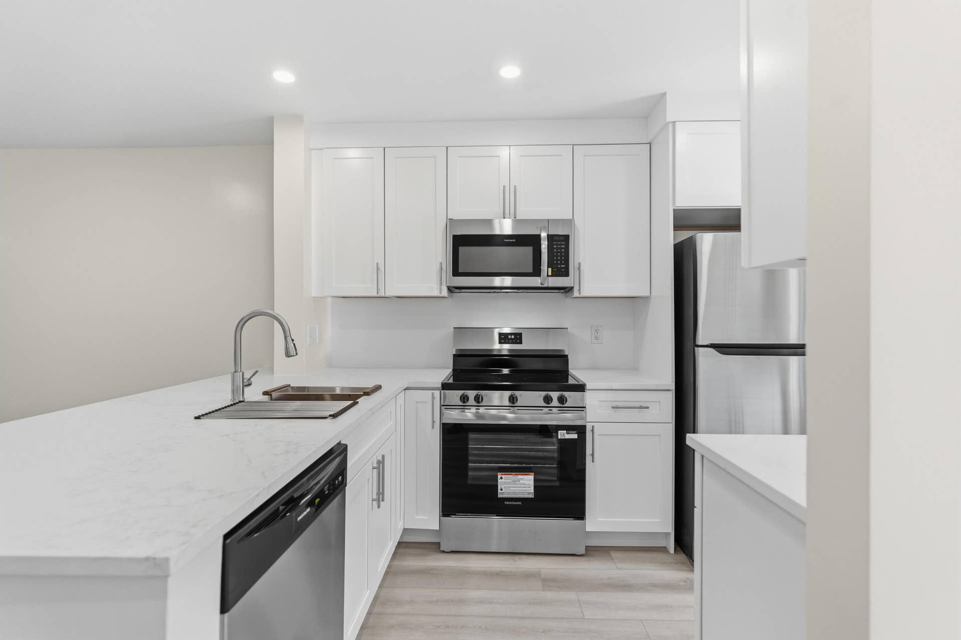 A brand NEW custom kitchen with quartz countertops, Eat in Bar, soft-close cabinets, stainless-steel appliances and ALL NEW ELECTRIC, PLUMBING, AC, AND HWH!