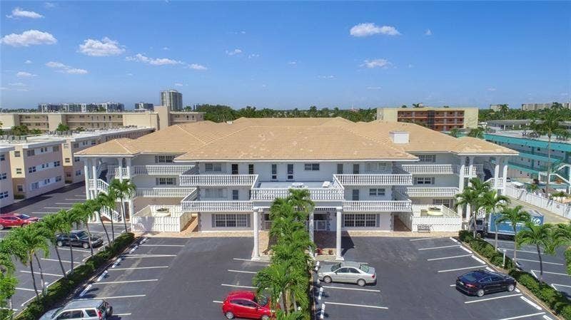 BEACH AND BOAT LOVERS DREAM LOCATION!.., FEATURING PRIVATE DEEDED BEACH ACCESS, COMMUNITY BOAT DOCK, NO FIXED BRIDGES, 1 CANAL FROM THE INTRACOASTAL WITH 6 BOAT SLIPS! Located in desirable North Leisure Gardens COMPLETELY REMODELED 2-bed, 2-bath, 1st floor, corner unit features EVERYTHING BRAND NEW!, a custom kitchen with quartz countertops, soft-close cabinets, stainless-steel appliances and ALL NEW, ELECTRIC, PLUMBING, HWH AND AC UNIT.