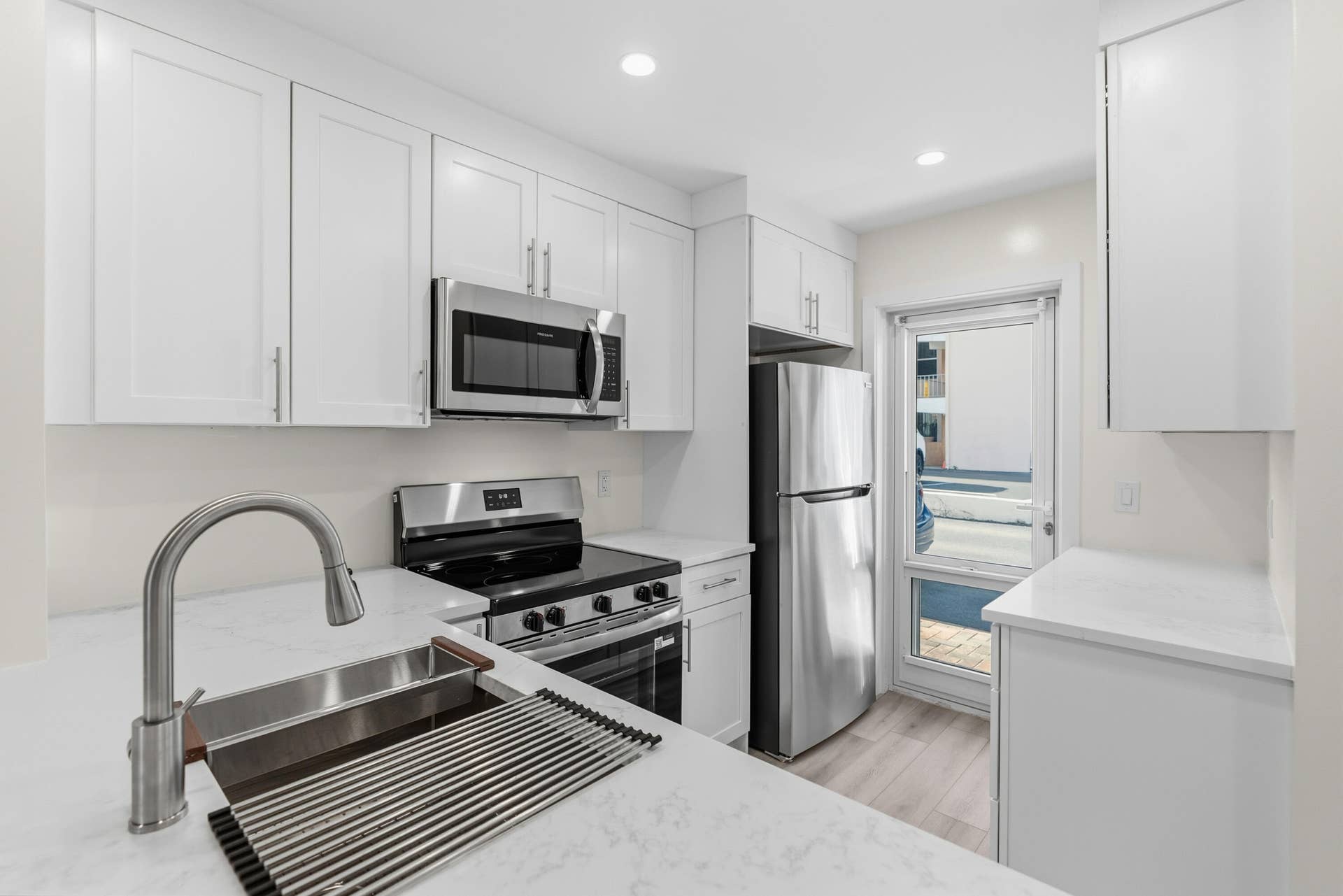 A brand NEW custom kitchen with quartz countertops, Eat in Bar, soft-close cabinets, stainless-steel appliances and ALL NEW ELECTRIC, PLUMBING, AC, AND HWH!