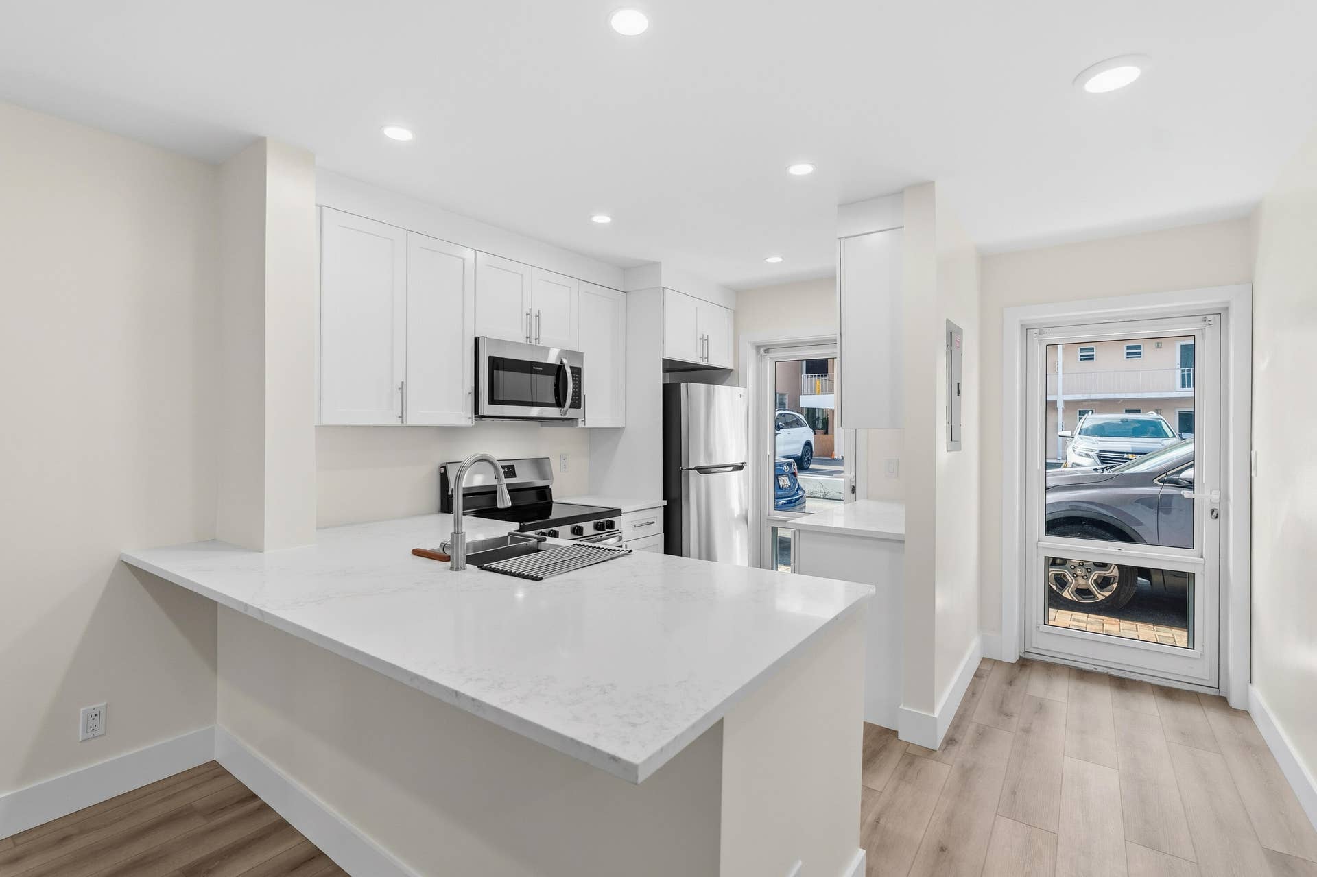 A brand NEW custom kitchen with quartz countertops, Eat in Bar, soft-close cabinets, stainless-steel appliances and ALL NEW ELECTRIC, PLUMBING, AC, AND HWH!
