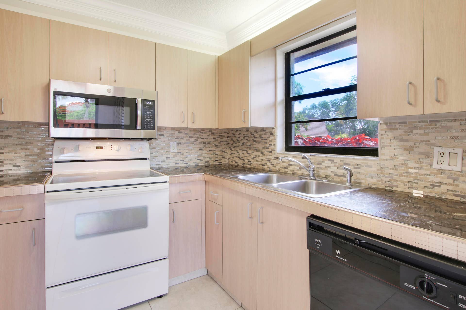 326 Jupiter Lakes Boulevard, #2318d, Jupiter, FL 33458 The kitchen offers a window for natural light and a dishwasher.