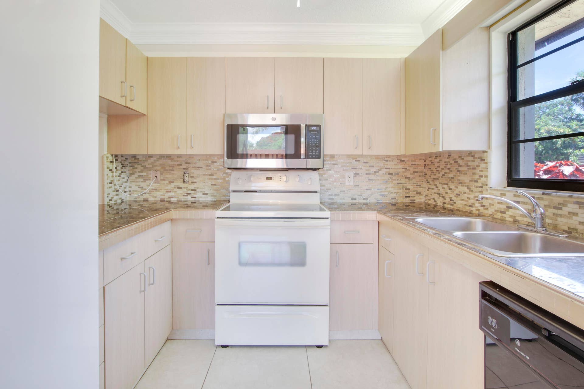 326 Jupiter Lakes Boulevard, #2318d, Jupiter, FL 33458 The kitchen offers an electric stove and microwave.