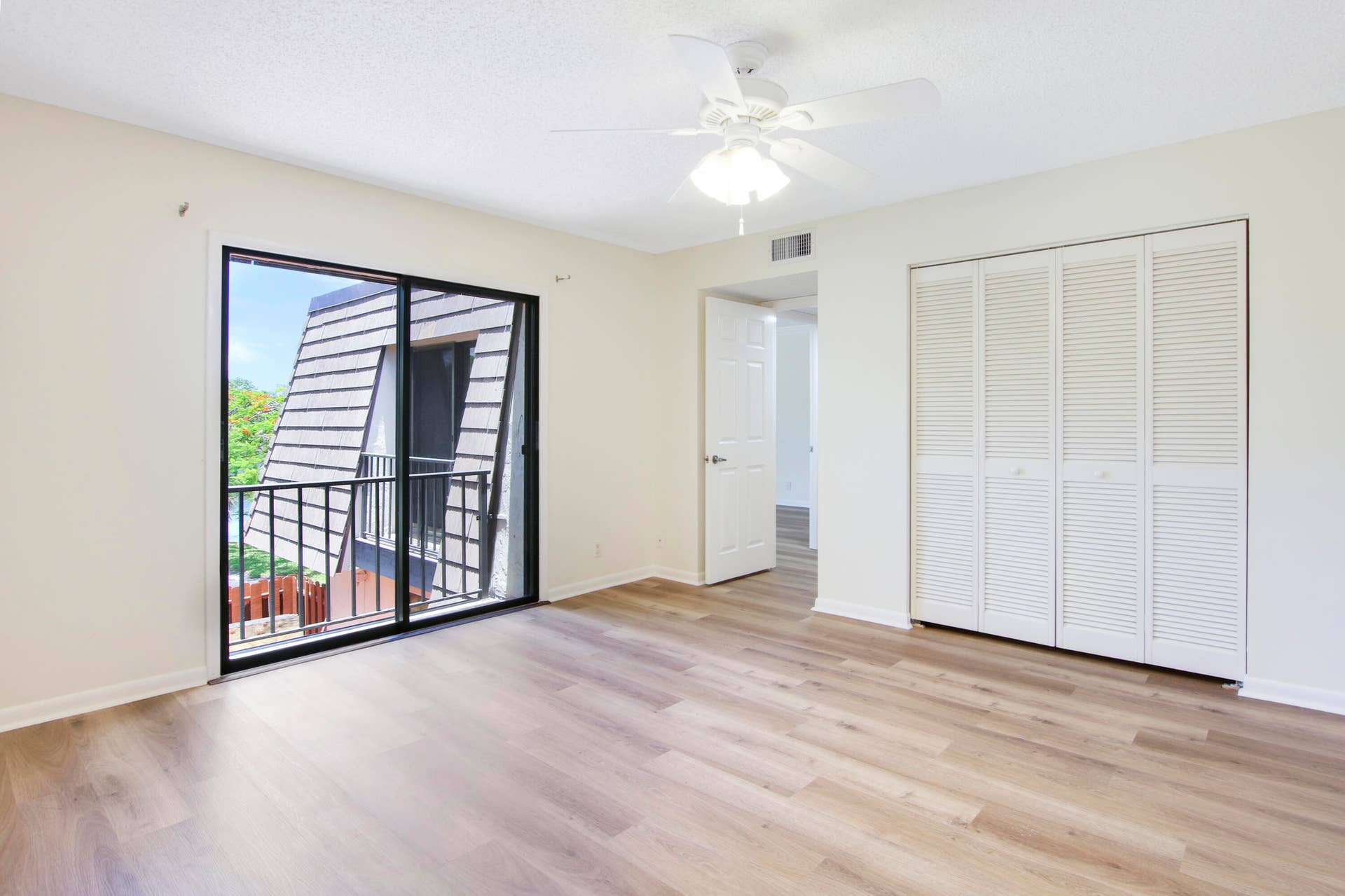 326 Jupiter Lakes Boulevard, #2318d, Jupiter, FL 33458 Bedroom 2 offers a sliding glass door that overlooks the patio and ample closet space.