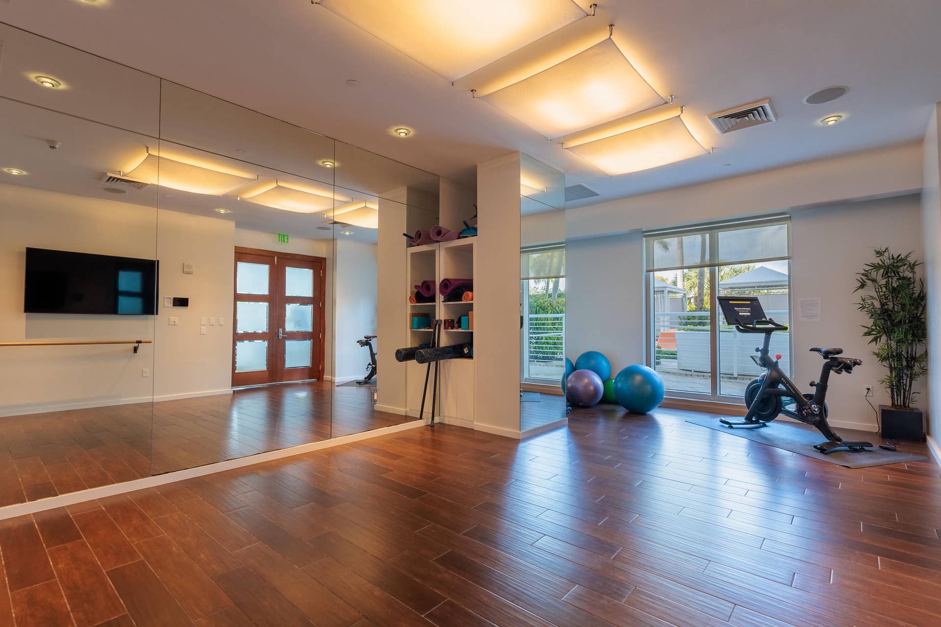 dance & yoga studio with a peloton machine off of the gym